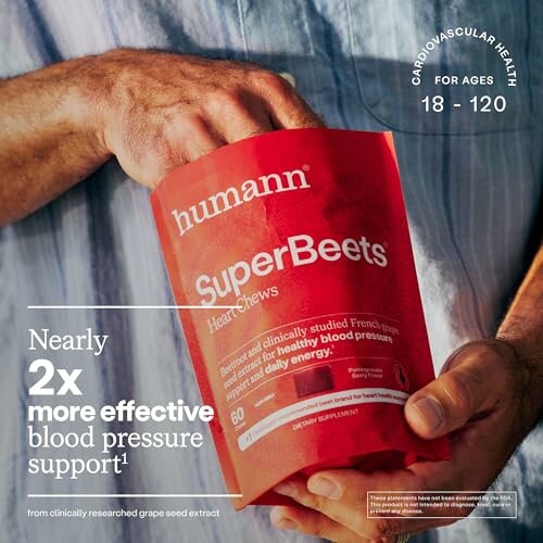 Hand holding a bag of Humann SuperBeets Heart Chews for cardiovascular health.
