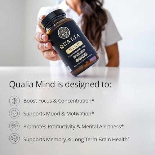 Person holding Qualia Mind supplement with benefits listed.